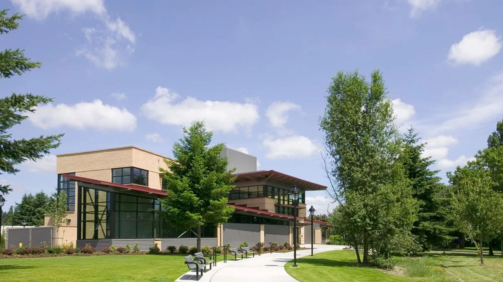 Lobby of the Redmond Community Center at Marymoor Village, with tall windows, a curved desk, and orange chairs.